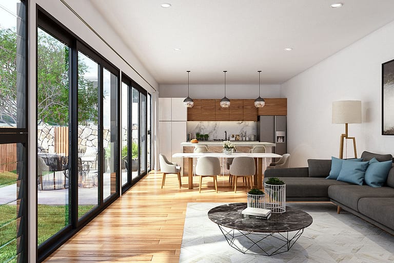 Rendering interni, open space con divano e cucina a vista con ampia porta a vetri e giardino